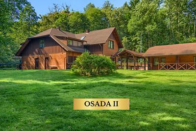 The Osada II building at Wapionka Manor stands among greenery.
