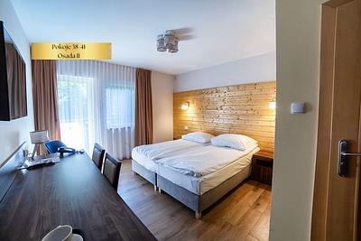 The Comfort Plus room in Osada II has two beds and large windows leading onto the terrace.