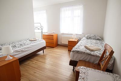 A double room with a chest of drawers and a small table at the Hajduczek agritourism.