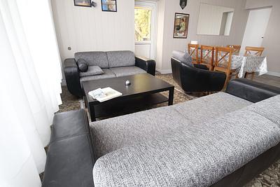 Living room with sofas and a dining table at the Hajduczek farm stay